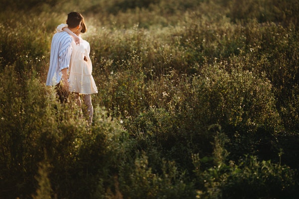 couple-kissing-surrounded-with-plants-1415129-1