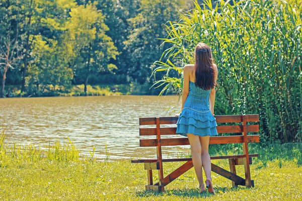 full-length-rear-view-of-a-woman-overlooking-calm-lake-322032