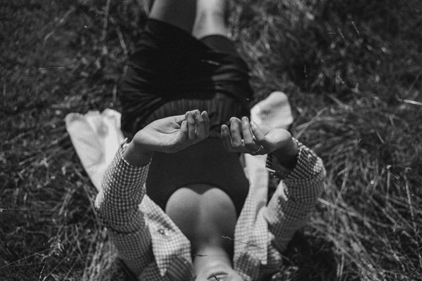grayscale-photography-of-person-lying-on-grass-3142535-1