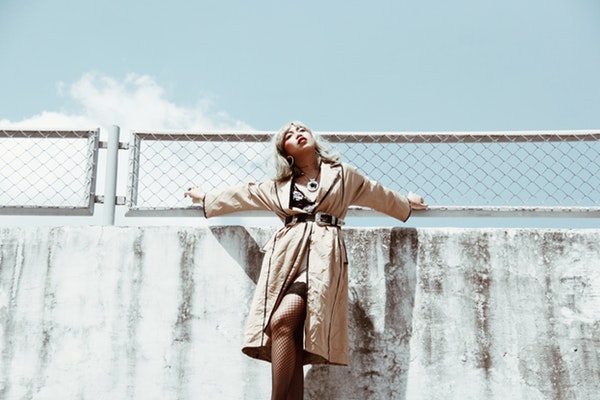 low-angle-photo-of-woman-wearing-brown-coat-3155469