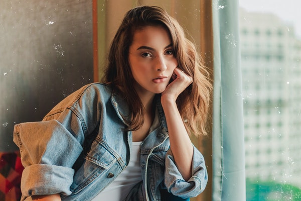 photo-of-woman-sitting-with-her-hand-on-her-cheek-2234623