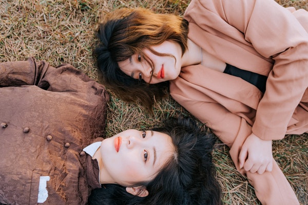 photo-of-women-lying-down-on-grass-3571373