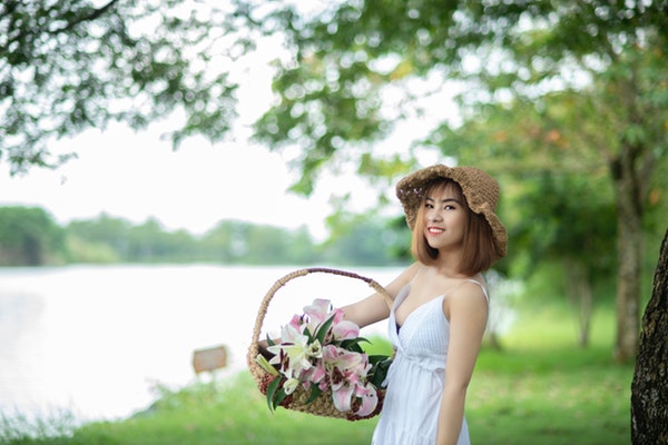 tilt-shift-photography-of-woman-holding-basket-1279907