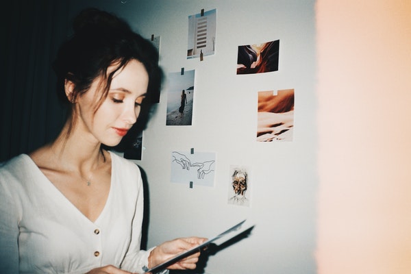 woman-in-white-scoop-neck-shirt-holding-a-paper-3589725