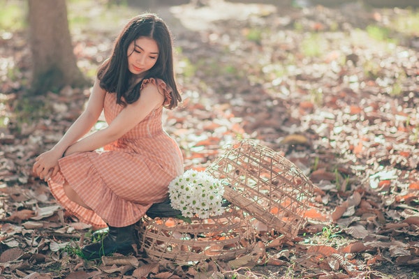woman-sitting-beside-a-flower-bouquet-995511-1
