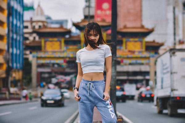 woman-standing-on-road-island-during-day-2315309