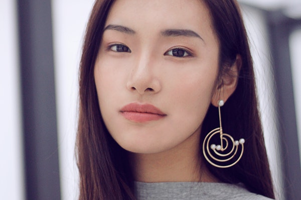 woman-wearing-silver-colored-drop-earring-3284696